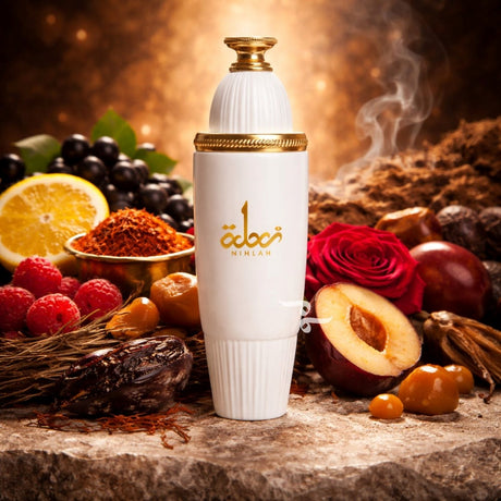 White bottle with gold accents on a stone surface surrounded by fruits, spices, and flowers.